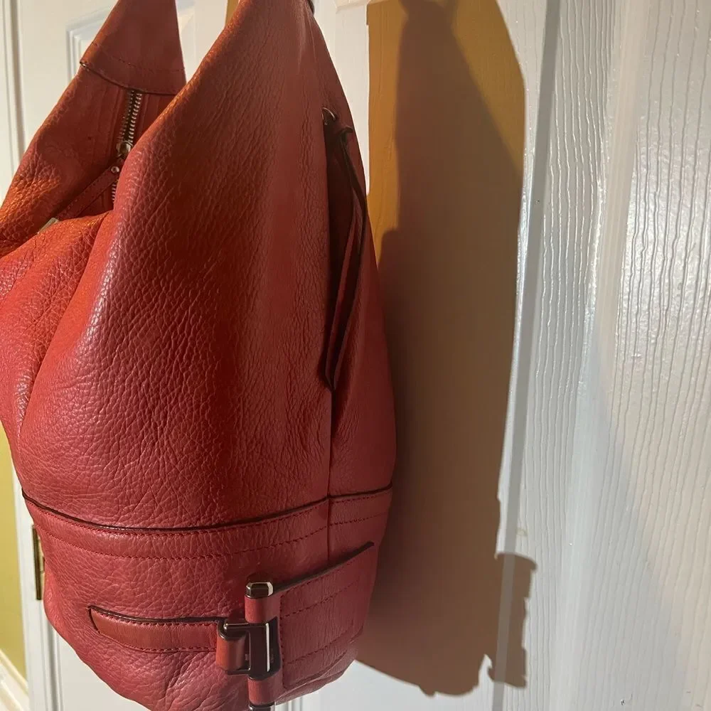 B Makowsky leather orange Hobo bucket style shoulder bag  silver tone hardwares